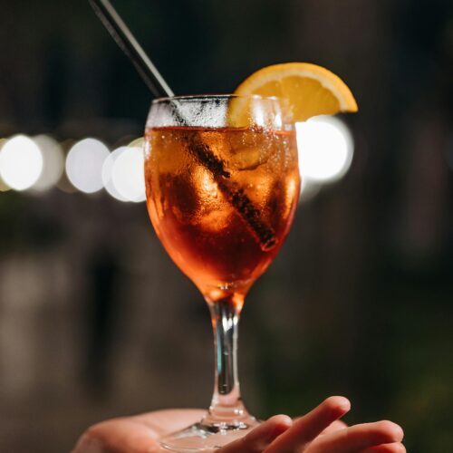 Glass of a non-alcoholic Aperol Spritz with a slice of orange